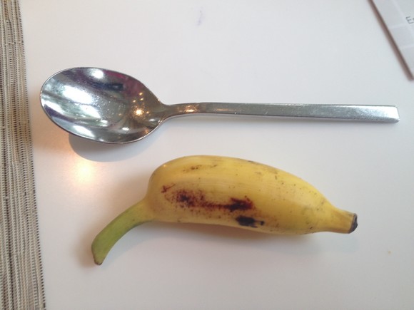 A banana measured against a teapoon